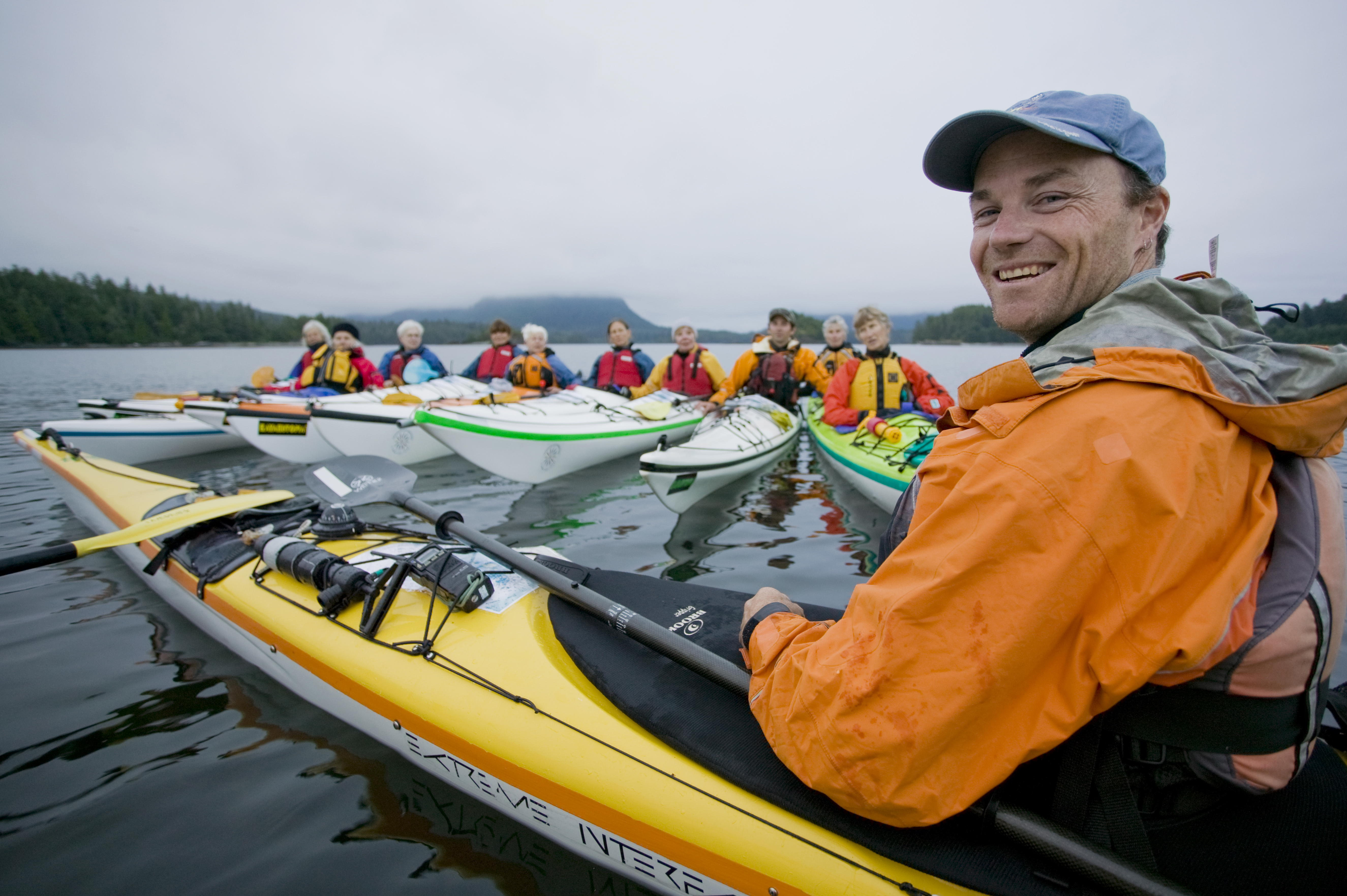 A Kayak guide gives instruction to a group of senior paddlers exploring the area around Spring Island in the Kyuquot Sound area of Northern Vancouver Island. Spring Island, Kyuquot Sound, Vancouver Island, British Columbia, Canada.