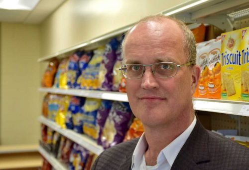 Prof. Mike von Massow standing in front of a grocery store shelf