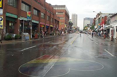 street in Toronto's Church and Wellesley neighbourhood with big rainbow heart chalked onto pavement of street