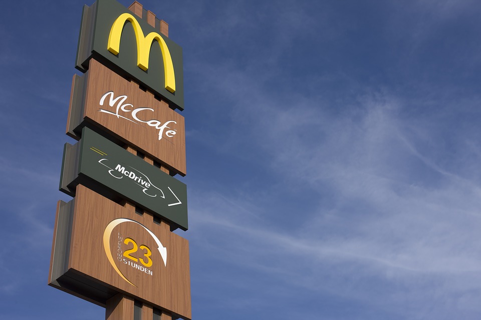 McCafe and McDonald's signs with sky in background