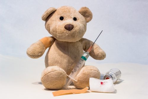 teddy bear and needle with vaccine kit