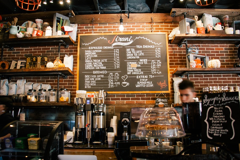Cafe barista and chalkboard menu