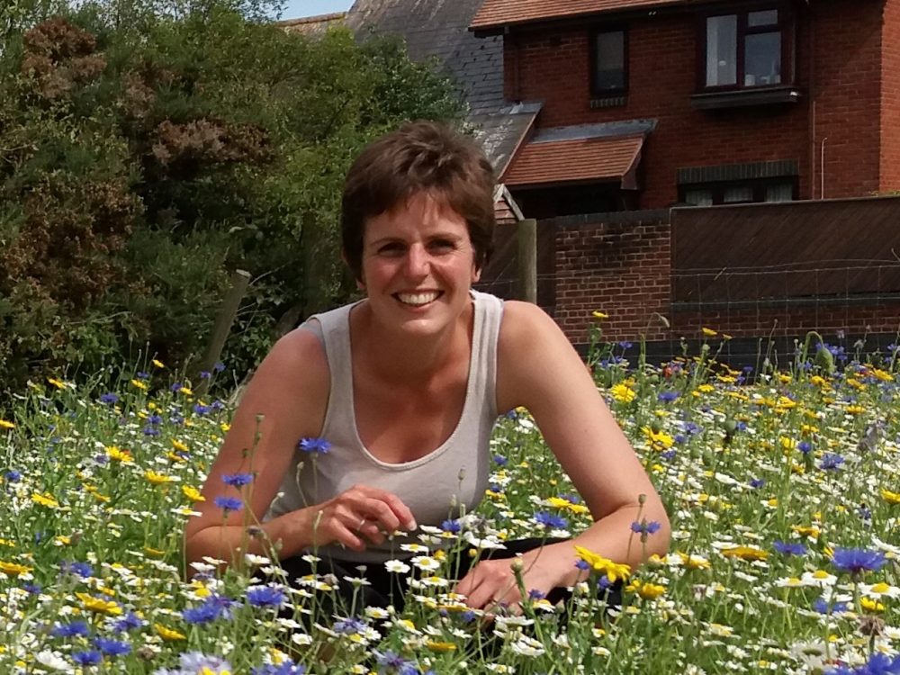 Elizabeth crouching in field of flowers