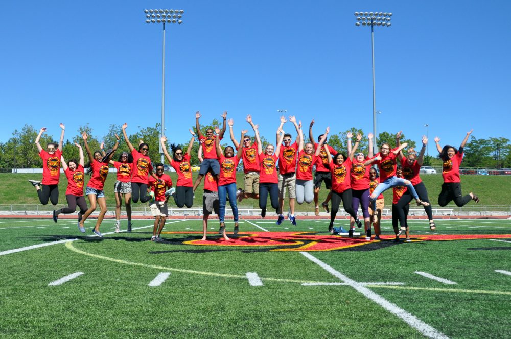 Students jump on the Gryphons football field