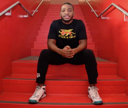 Gryphon sprinter Kuda Murasiranwa sits on red staircase in the U of G Athletic Centre