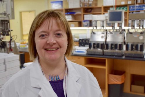 photo of Prof. Emma Allen-Vercoe standing in her lab
