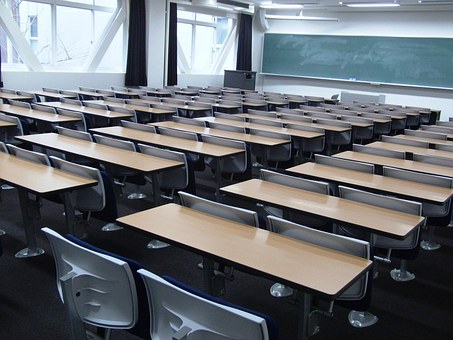 photo of rows of empty desks in a classroom