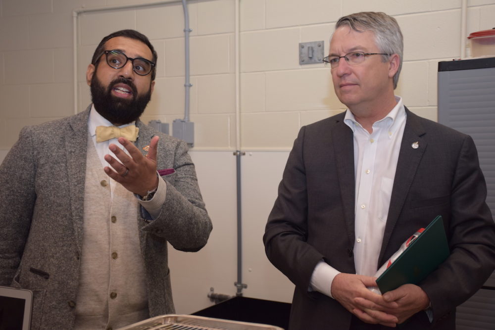 Two men discuss research