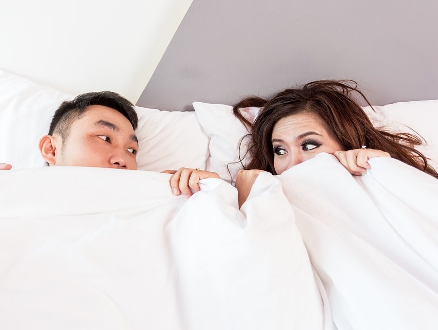 a photo of a couple in bed