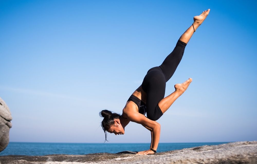 A photo of a woman performing yoga wearing leggings