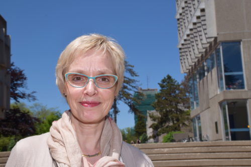 Sandra Parmegiani on campus steps in sunshine
