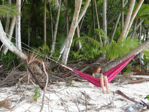 Young woman reading on a hammock