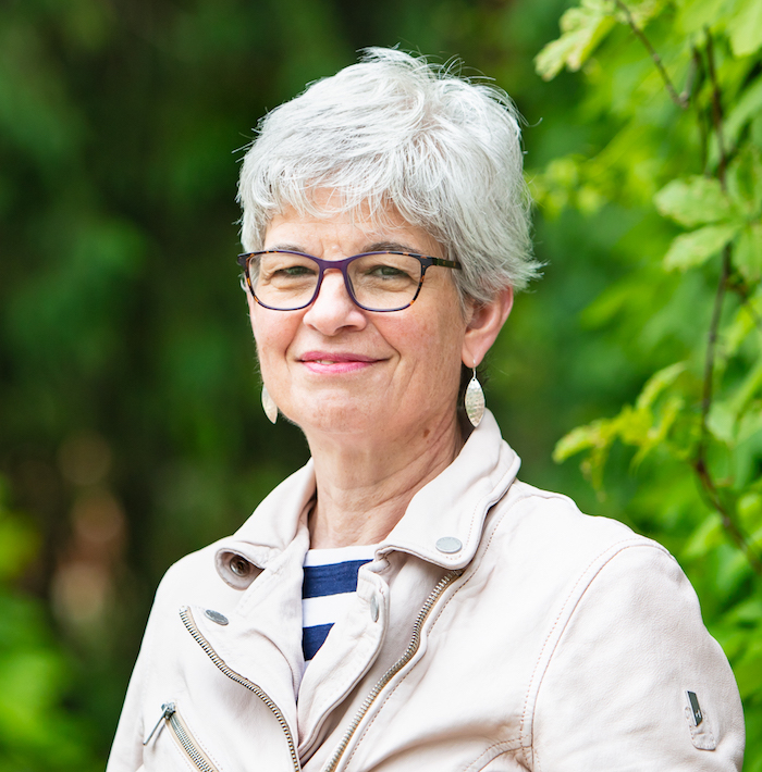 Professor in forested campus setting