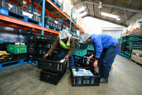 Two men working in a food warehouse