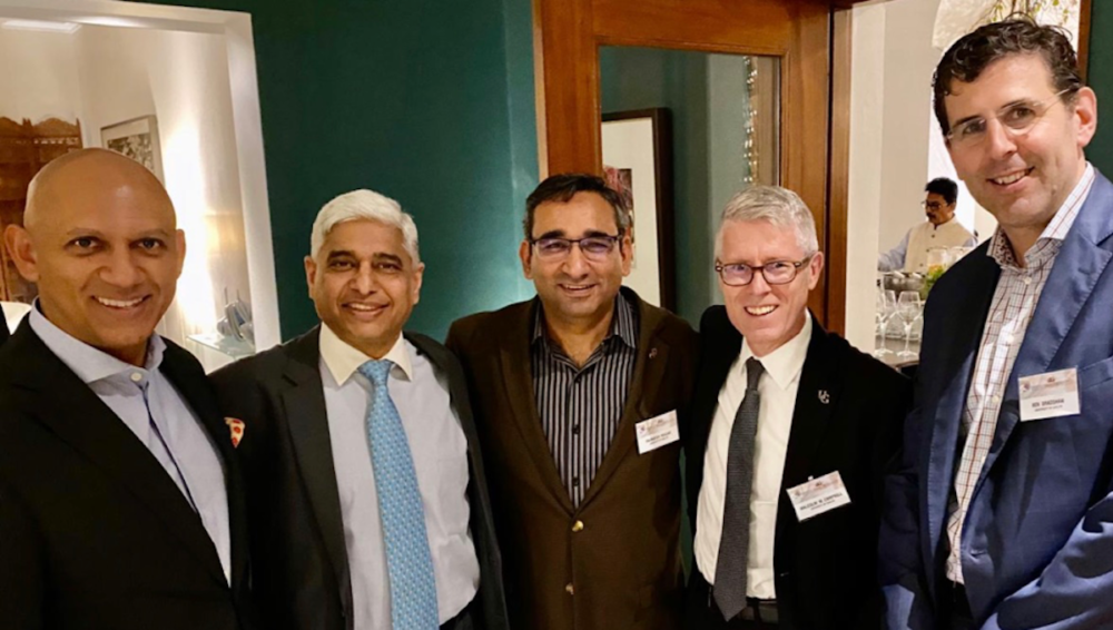 Five men smiling following formal talks