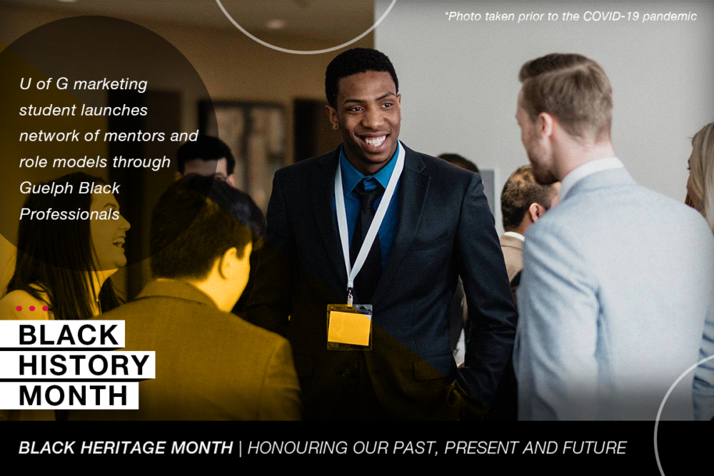 Bankole Alade stands in the centre of a group at a pre-pandemic gathering.