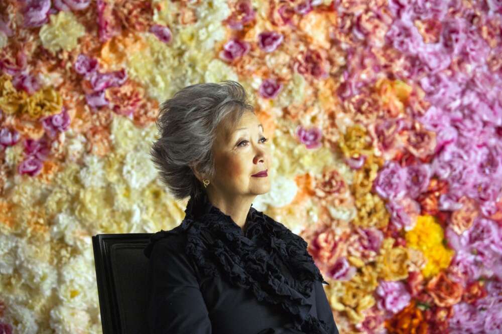 Adrienne Clarkson with pink, orange and yellow floral pattern in the background
