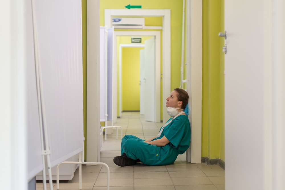 Woman doctor seated in a hospital hallway