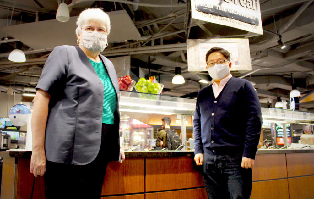 Drs. Paula Brauer and Sunghwan Yi stand near a salad bar