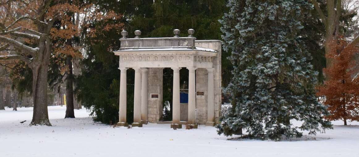 The portico surrounded by trees on a snowy day