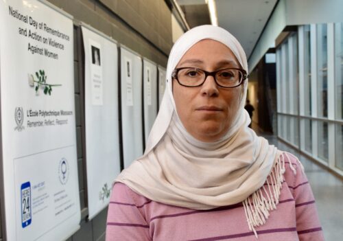 Women in university hallway wearing white hijab