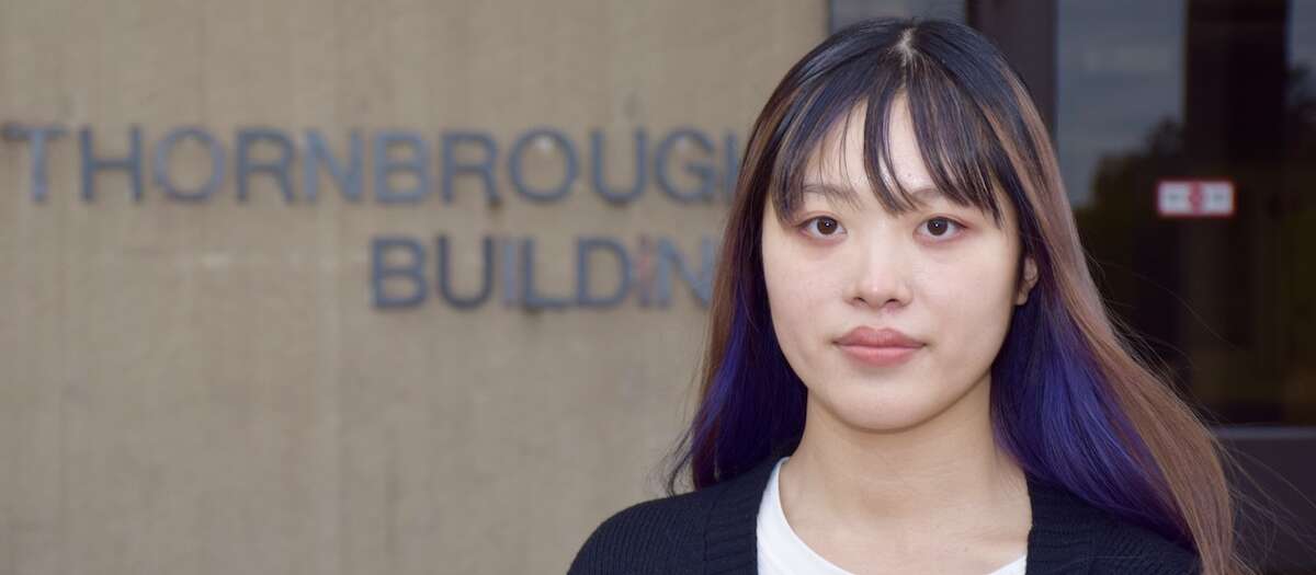 Young Asian woman in front of U of G engineering building