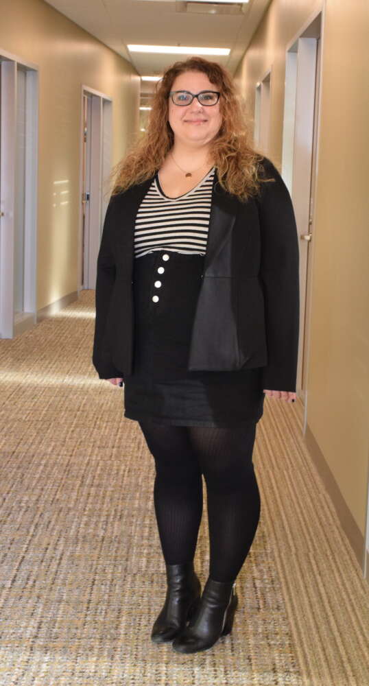 Full-length photo of woman in black skirt and jacket