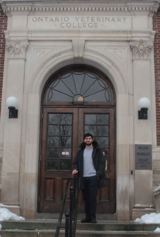 Kawarsky stands on the steps to the Ontario Veterinary College.