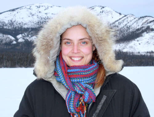 Dr. Allyson Menzies stands before snowy mountains