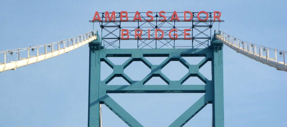 A closeup of the sign at the top of the Ambassador Bridge
