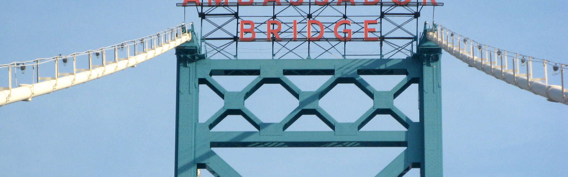 A closeup of the sign at the top of the Ambassador Bridge