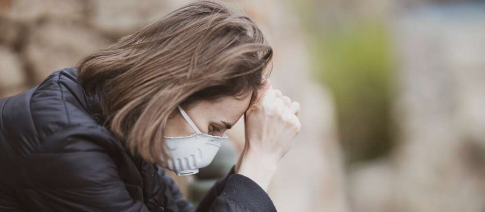woman in black leather jacket wearing white framed eyeglasses covering her face