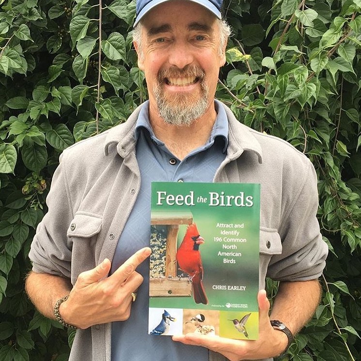 Chris Earley holds his book "Feed the Birds".