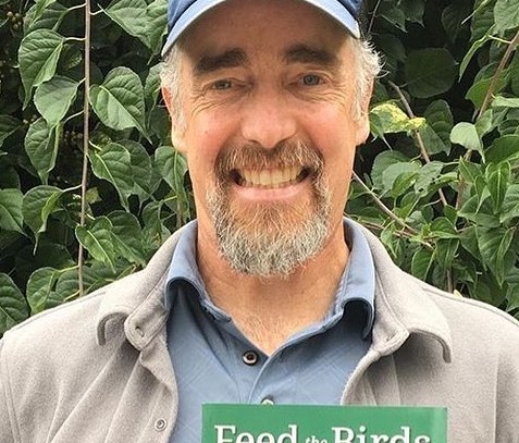 Chris Earley holds his book "Feed the Birds"
