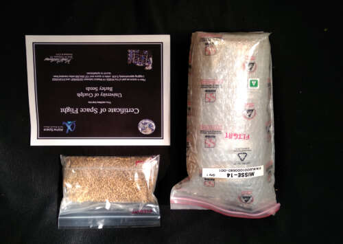 A bag of barley seeds is pictured beside its certificate from space flight.