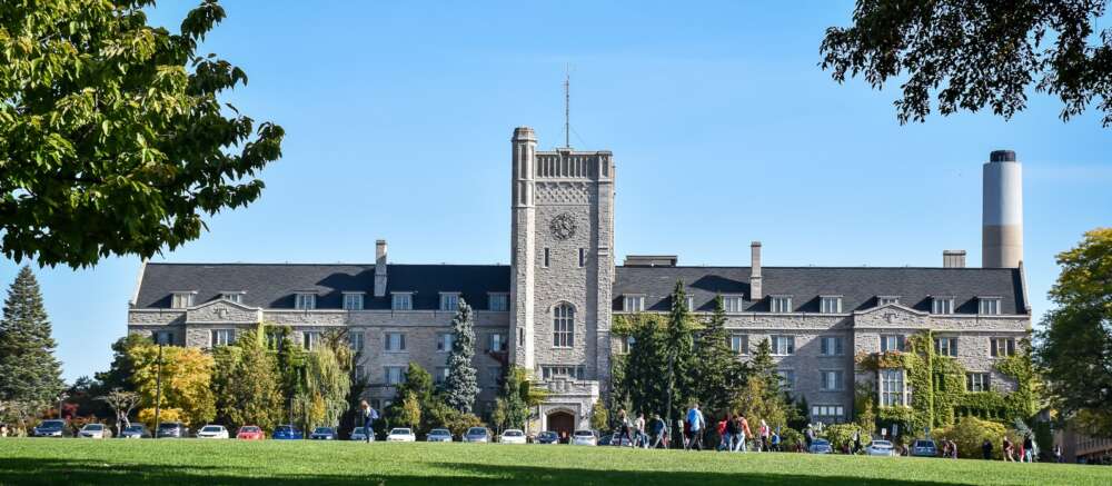 A wide view of Johnston Hall and the green field before it