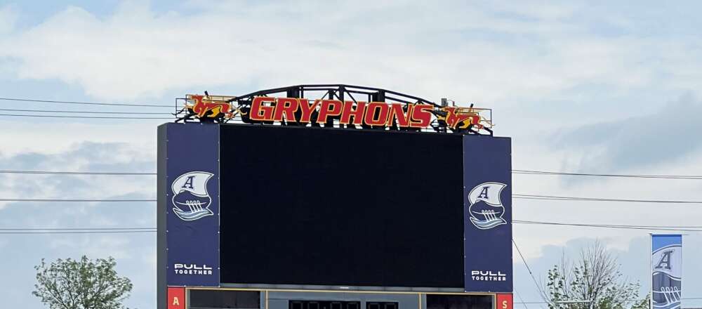 A scoreboard at U of G's Alumni Stadium decorated with Argos' banners.
