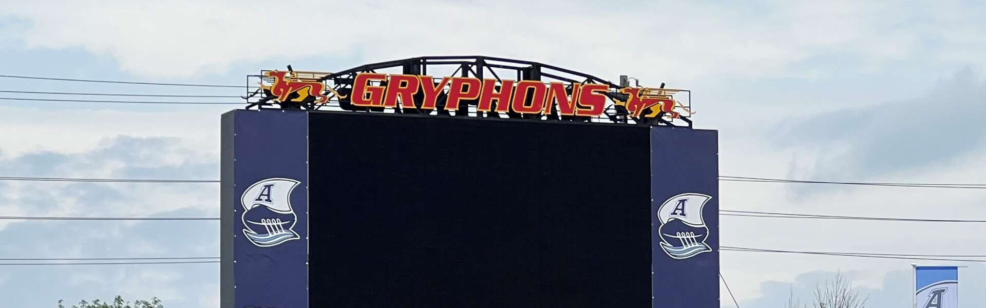 A scoreboard at U of G's Alumni Stadium decorated with Argos' banners.
