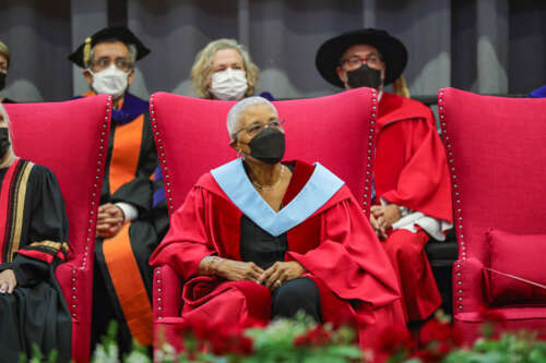 Dr. Mary Anne Chambers seated onstage during 2022 convocation.