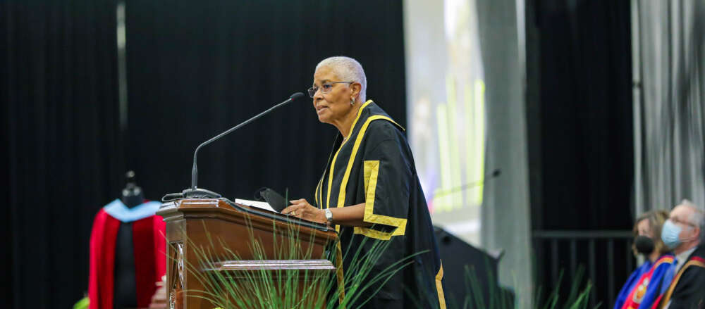 Dr. Mary Anne Chambers stands at podium speaking at 2022 convocation.