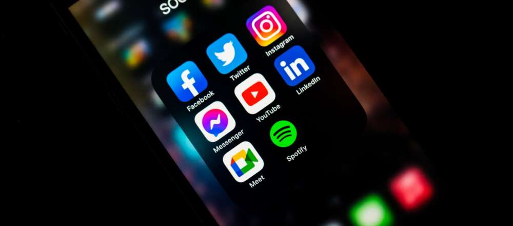 Social media icons on a phone screen.