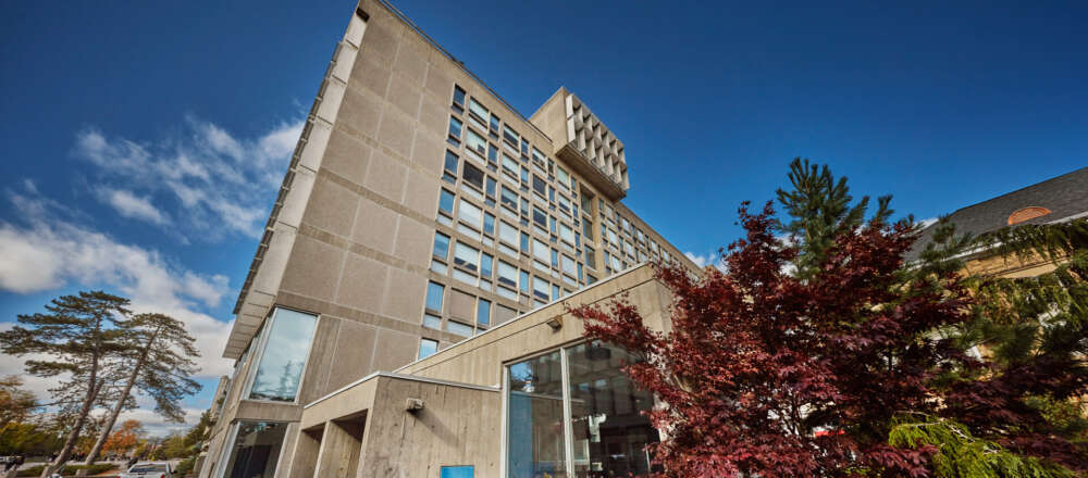 A grey building against a blue sky
