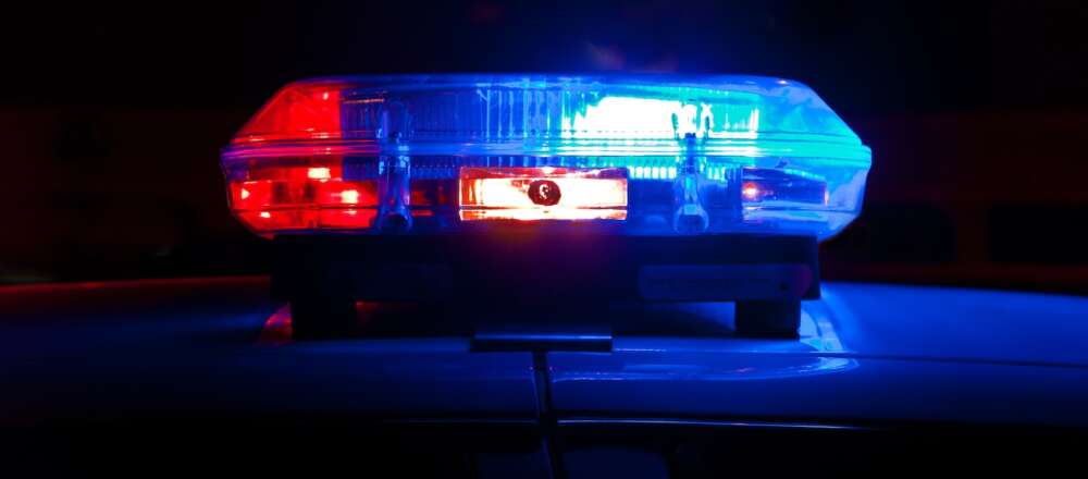 An image of red and blue police lights against a black background.