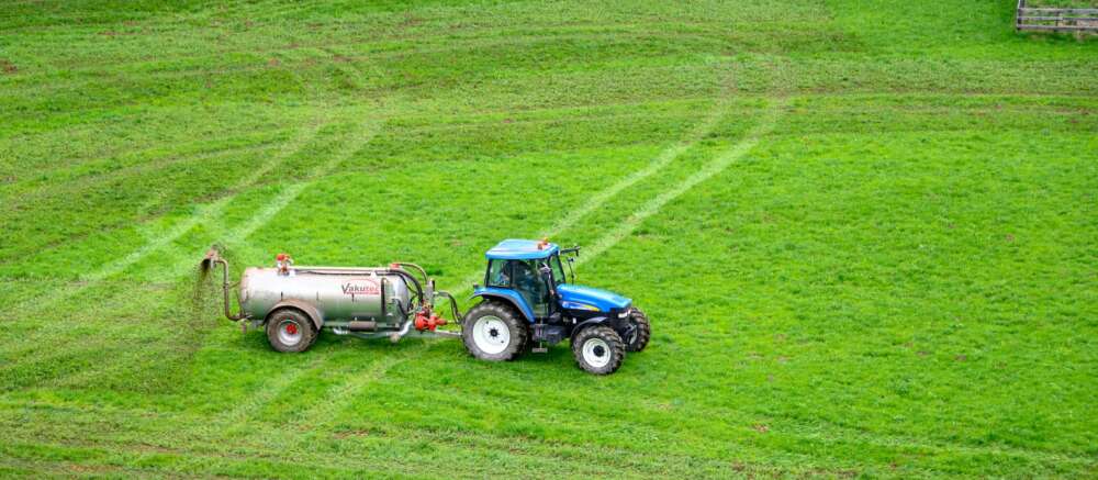 wide shot of a tractor on grass field