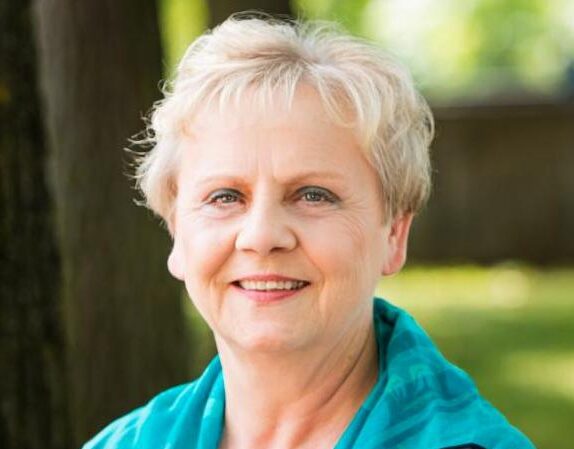 woman outdoors smiles at camera