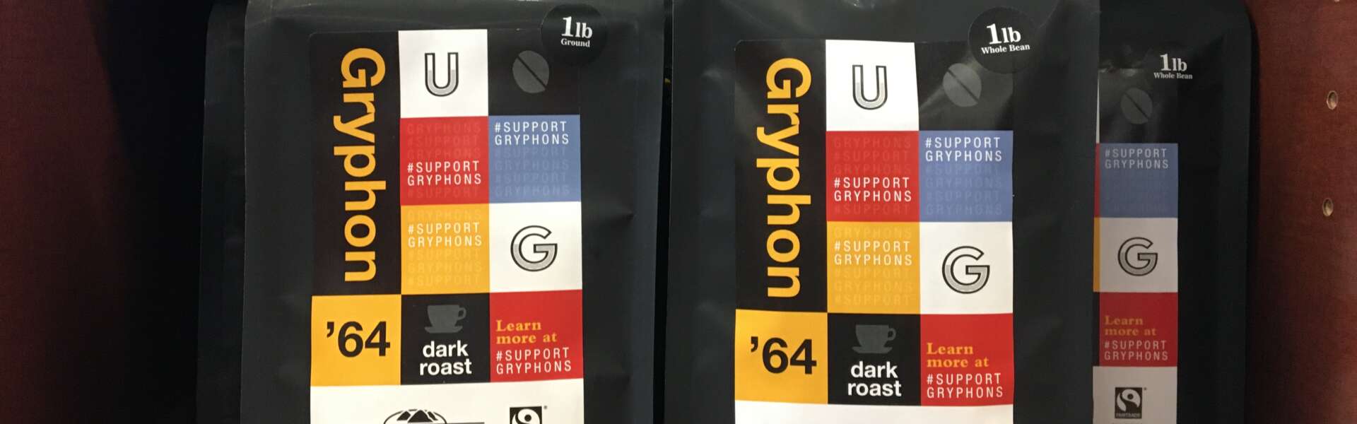 Black coffee packages with colourful designs arranged on a shelf