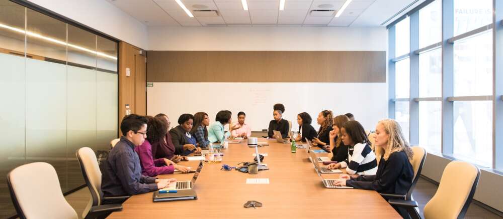 people having meeting on rectangular brown table