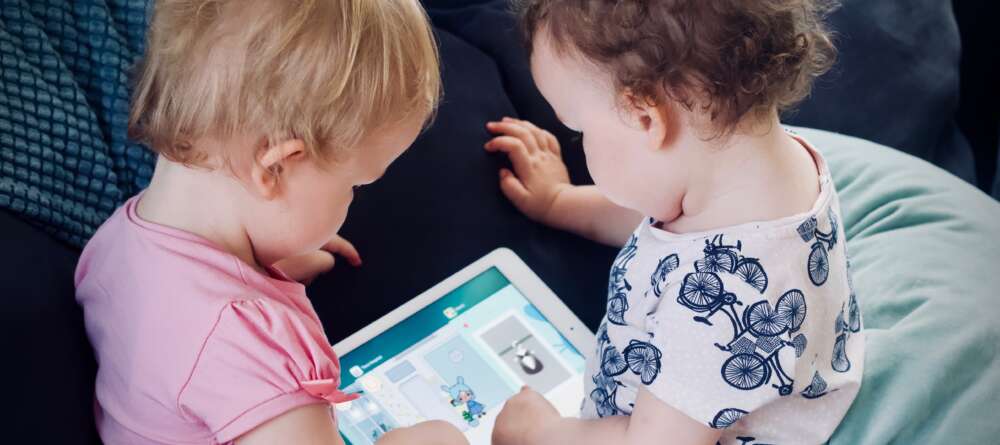 Toddlers use a tablet/
