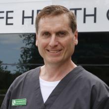 Dr. Chris Dutton smiles for a photo