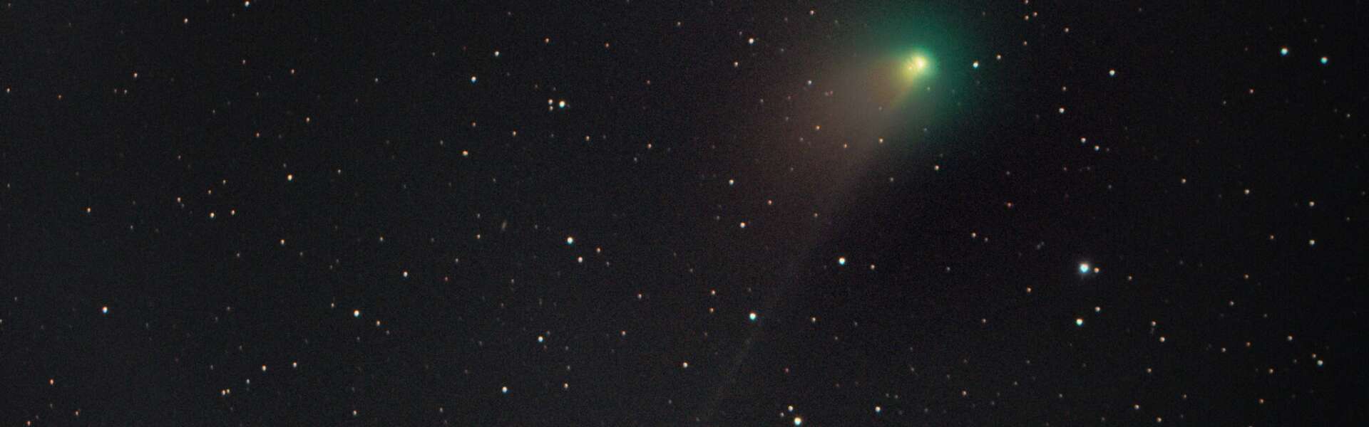 A green comet in a starry sky